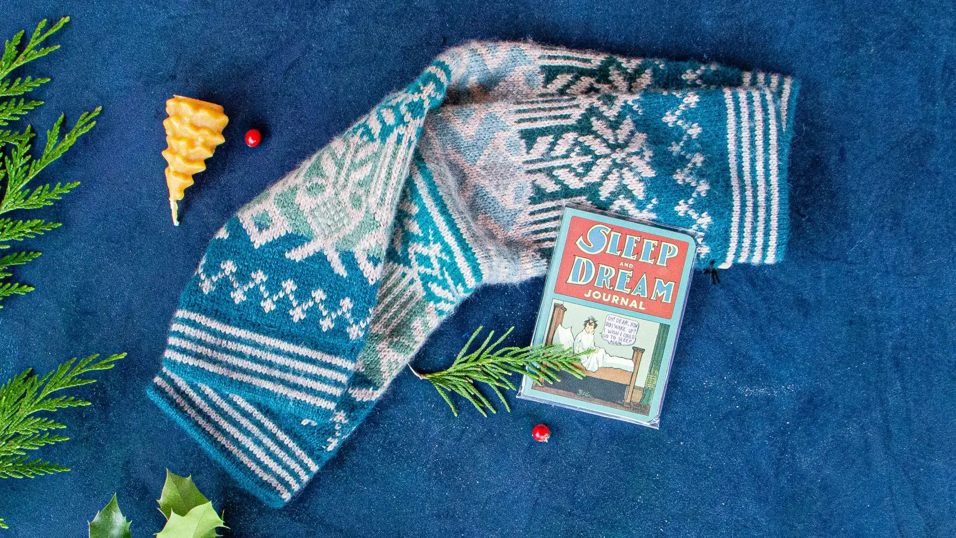 Beeswax candle shaped like Christmas tree, Andes Gifts fair trade wool scarf, Sleep and dream journal.