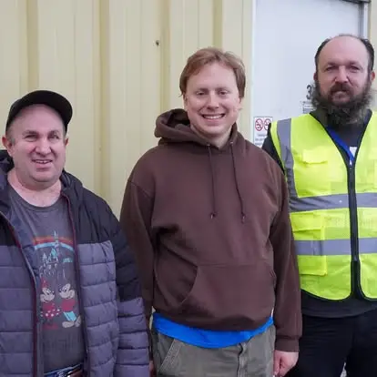 Group of three team members at Garten Services, including one person in a high-visibility vest.