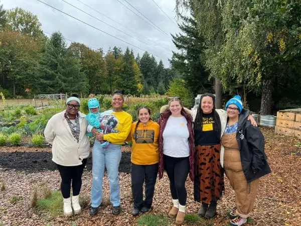 Members of the Black Joy Oregon team pose together at Black Joy Farm, where they grow fresh organic food and build community.