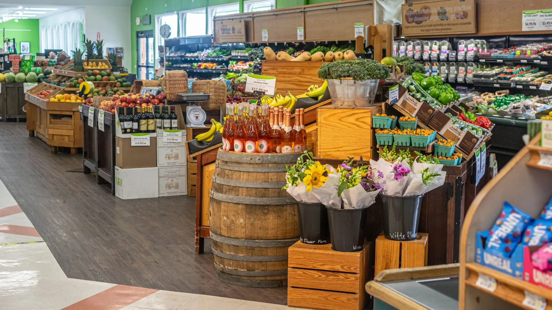 LifeSource Natural Foods produce department filled with fresh organic fruits, vegetables, and flowers.
